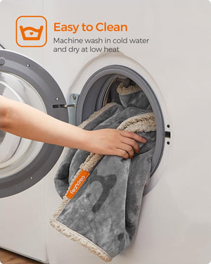 Person placing a towel with Tech4ever branding into a washing machine at Pet Servo