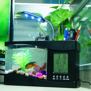 Desk organizer with fish tank, digital clock, and pen holder on a desk at Pet Servo
