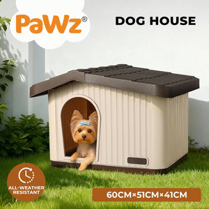 A small doghouse with a cream exterior and dark brown roof/trim, shown on grass with a small dog peeking out of the doorway. The image includes the brand name PaWz, the text 'DOGHOUSE,' and size information '60CMx51CMx41CM' plus an 'All-Weather Resistant' badge at Pet Servo