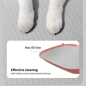 A close-up of white cat paws standing on a gray diamond-plate metal surface, with an inset product callout showing a pink and white pet mat and text reading 'Max fill line' and 'Effective cleaning Soft rubbery mat to stop material sticking' at Pet Servo