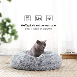 Cat sitting on a fluffy donut-shaped pet bed with text about security at Pet Servo