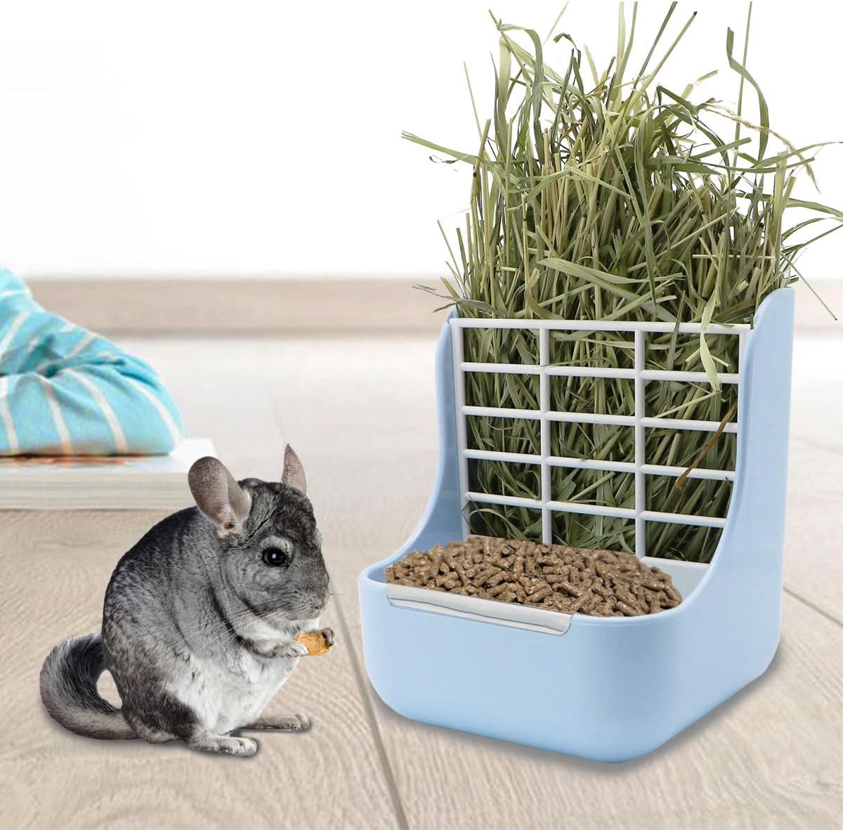 Pet feeder with hay and food for small animals on a light wooden floor at Pet Servo