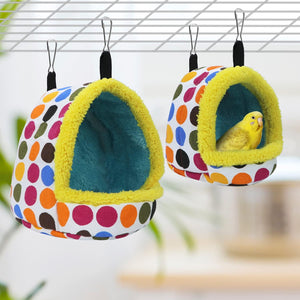 Colorful polka dot pet hammocks with a small yellow bird inside, hanging on a wire cage at Pet Servo