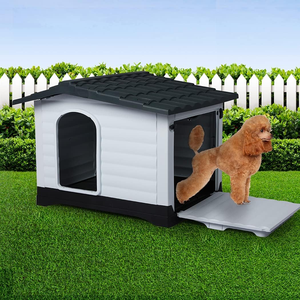 A small doghouse with a white exterior, dark gray roof and base, and a sliding door, shown on artificial grass with a fluffy light brown dog standing on the ramp in front at Pet Servo