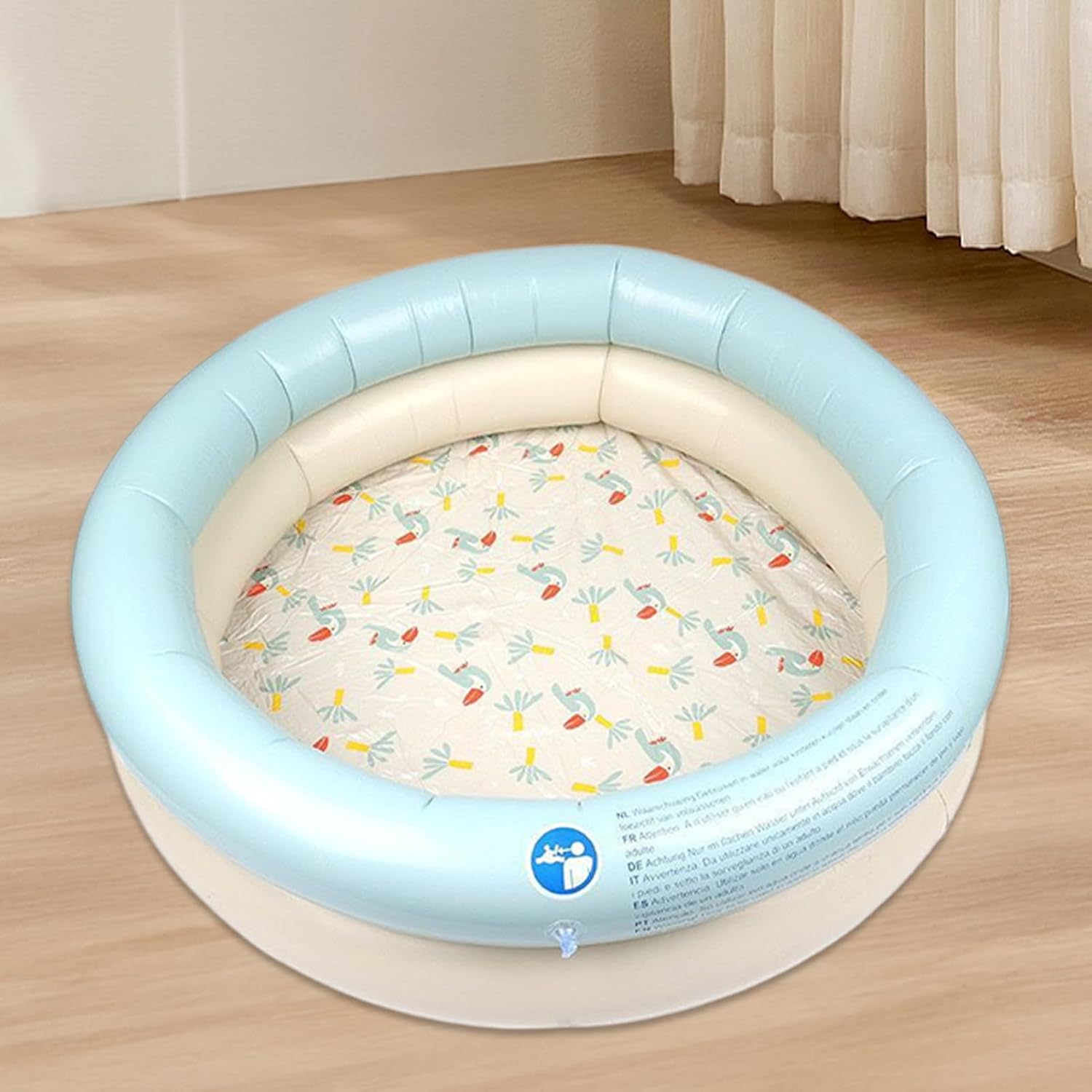 Inflatable baby playpen with floral pattern on a wooden floor at Pet Servo