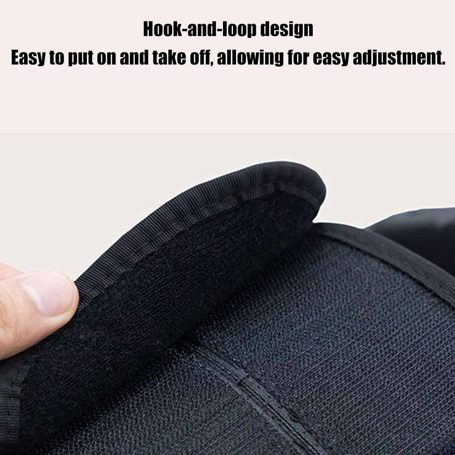 Black fabric with hook-and-loop design being adjusted by a hand on a light gray background at Pet Servo