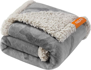Folded gray and beige blanket with a visible brand tag on a white background at Pet Servo