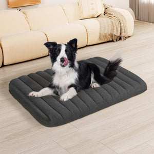 Dog lying on a gray inflatable pet bed in a living room at Pet Servo