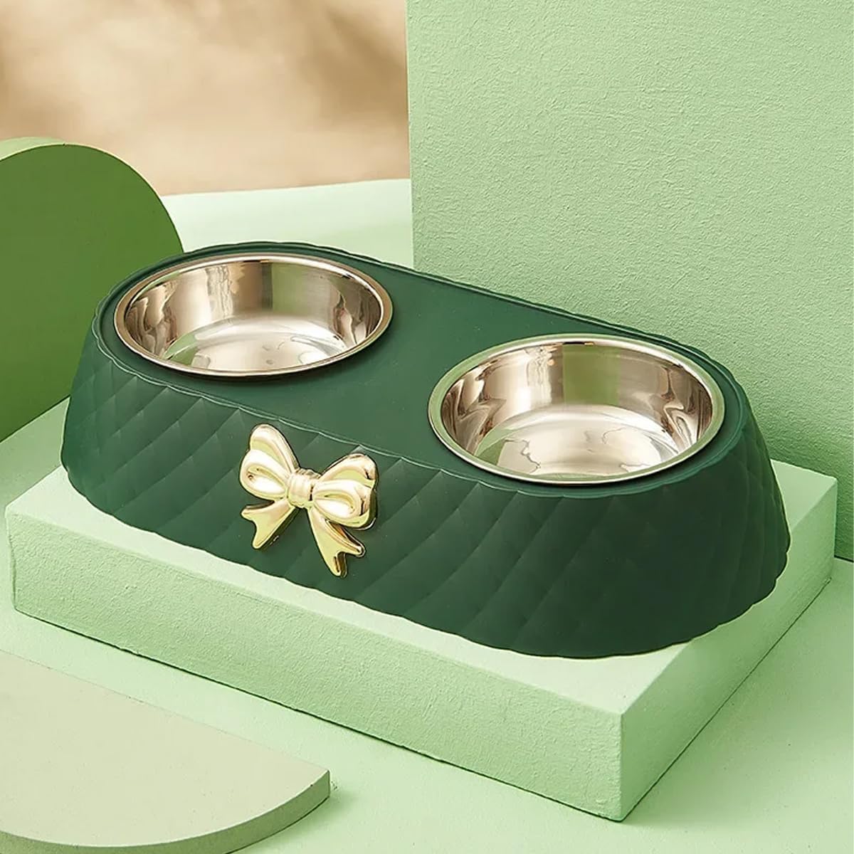 Green pet bowl with two silver bowls and a gold bow on a light green background at Pet Servo