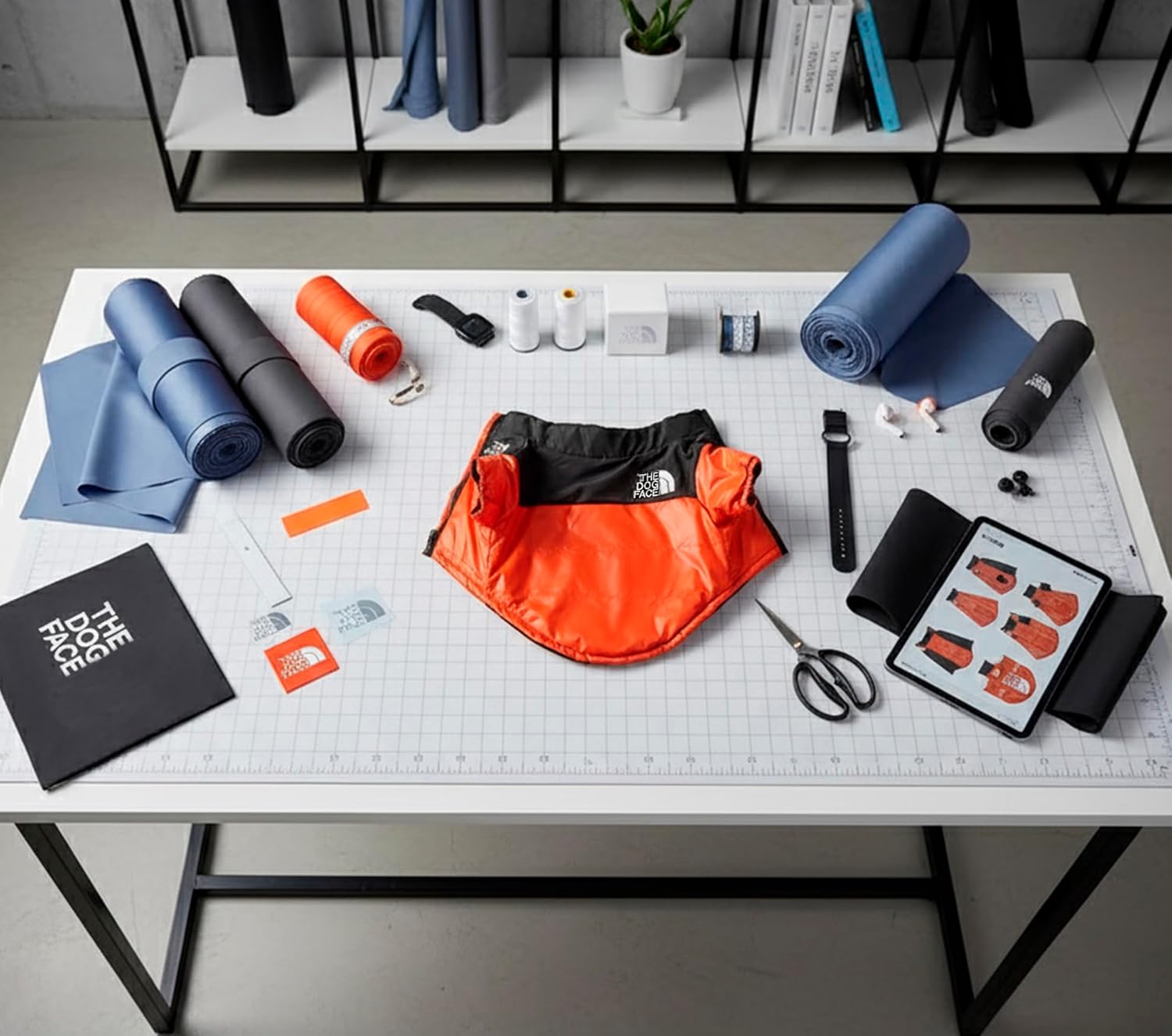Table with various items including yoga mats, a bag, and tools on a grid-patterned surface at Pet Servo