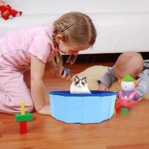 Child playing with a cat and toys on a wooden floor at Pet Servo