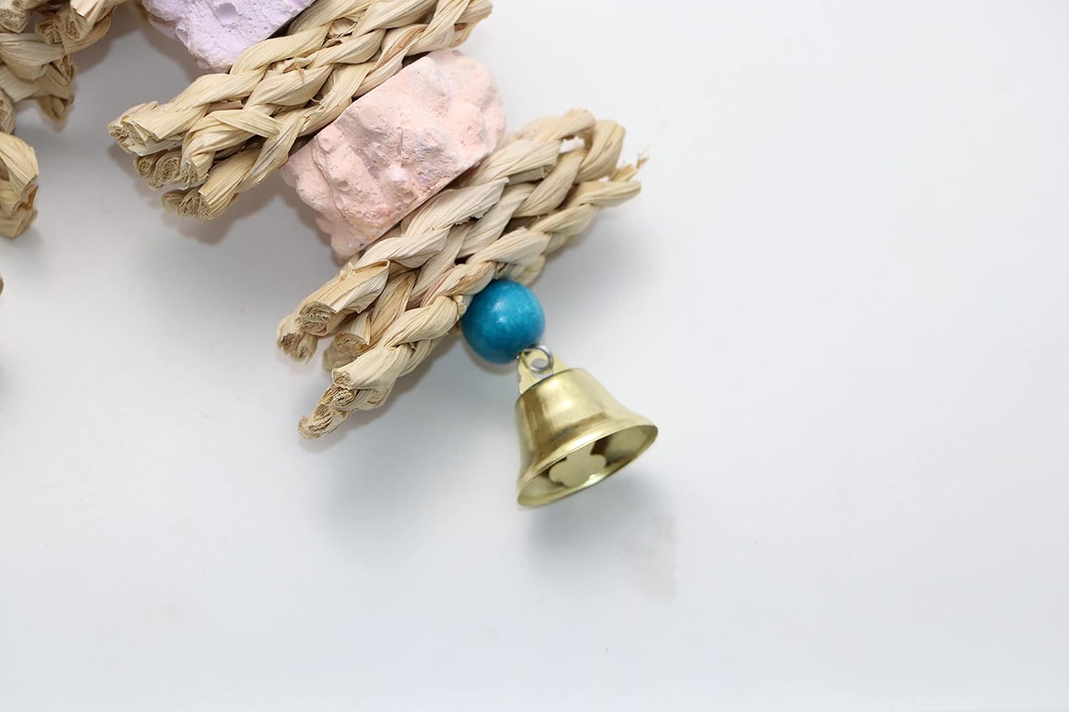 Woven cat toy with a bell and turquoise bead on a white background at Pet Servo