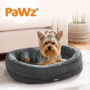 Dog lying on a gray pet bed with 'PaWz' branding in a home setting at Pet Servo