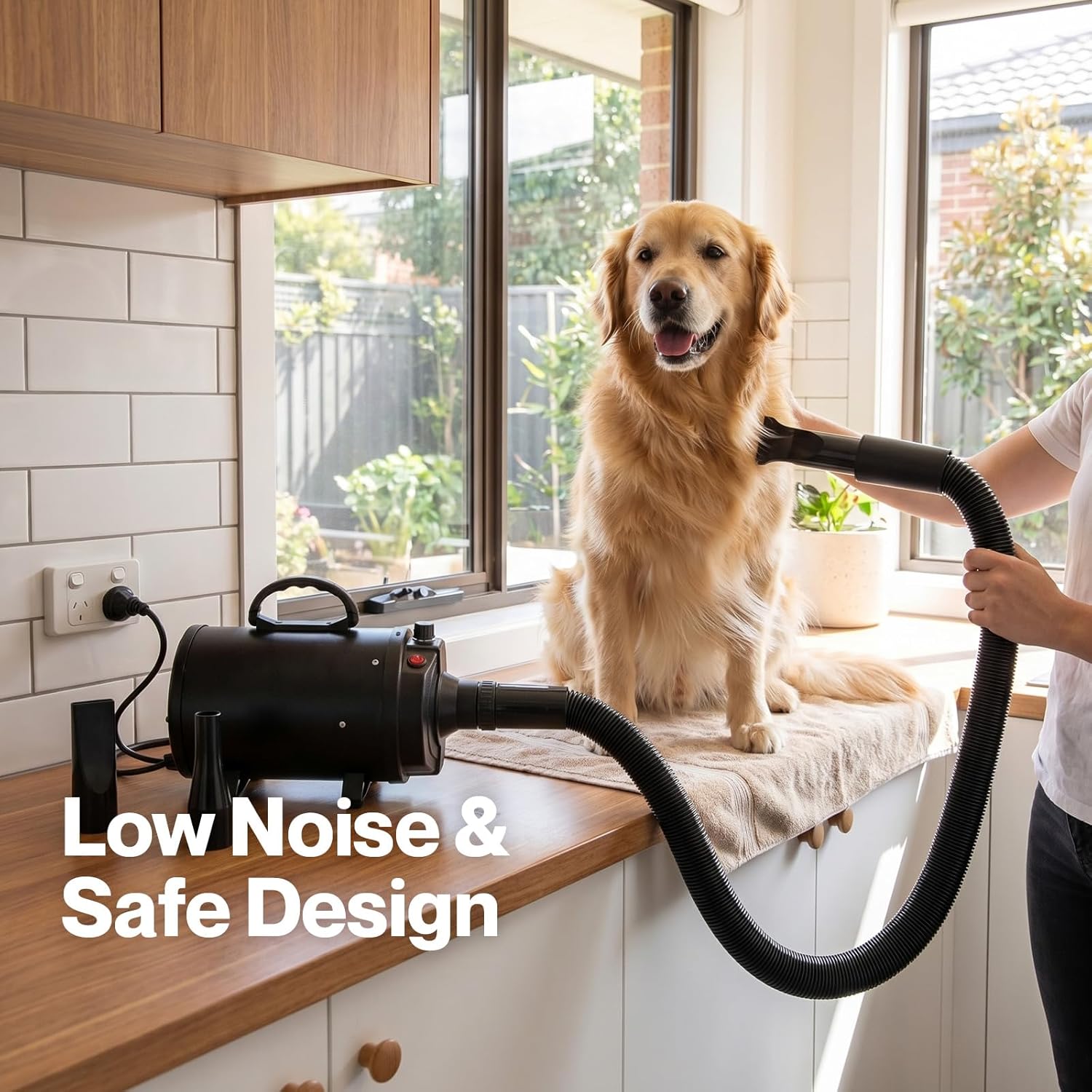 Dog being dried with a hair dryer in a kitchen, with text 'Low Noise & Safe Design' at Pet Servo