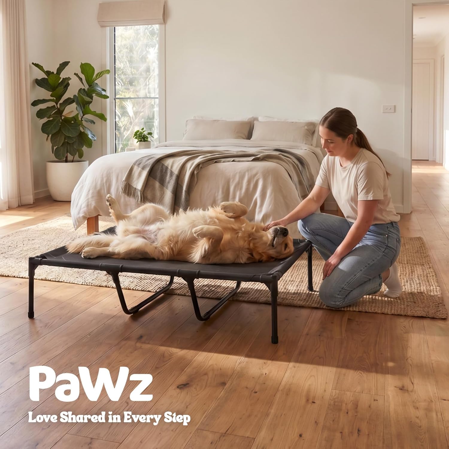 Woman petting a dog on a pet bed in a bedroom with 'PaWz' branding at Pet Servo