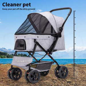 A pet stroller with a light gray fabric body and black frame, shown outdoors on a rocky beach with a blue sky and mountains in the background. A height measurement scale is printed on the right side of the image, and the text 'Cleaner pet off the dirty ground' appears in the top left corner at Pet Servo