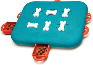 Pet puzzle toy with bone-shaped holes and treat dispensers on a blue and orange base at Pet Servo