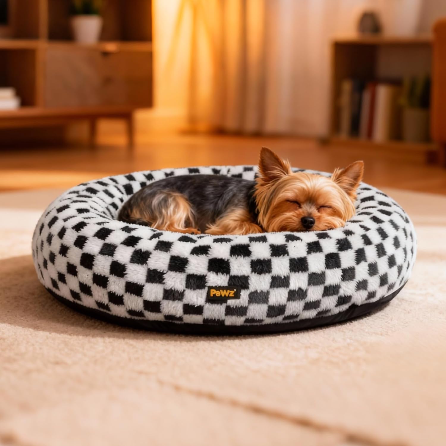 Dog resting on a checkered pet bed in a cozy room at Pet Servo