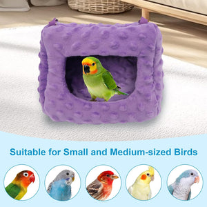 Purple bird nest with a green parrot inside on a light surface, suitable for small and medium-sized birds at Pet Servo