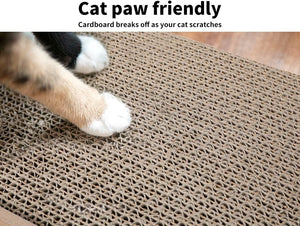 A close-up of a cat's paw pressing onto a brown corrugated cardboard scratching mat, with text at the top reading 'Cat paw friendly' and 'Cardboard breaks off as your cat scratches' at Pet Servo