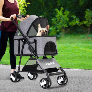 Person pushing a gray pet stroller with a dog inside, outdoors on a path at Pet Servo