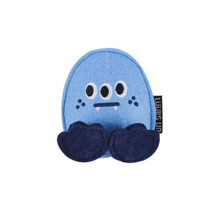 A light blue felt monster plush toy with three eyes, a black stitched mouth, small white teeth, and dark navy blue feet. A small black fabric tag on the right side reads 'LILIES UP' at Pet Servo