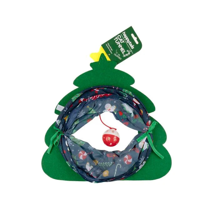 A Christmas-themed pet tunnel toy shaped like a green Christmas tree, featuring a patterned fabric tunnel with holiday motifs and a red ornament hanging from a string. It has a green hang tag attached at the top.