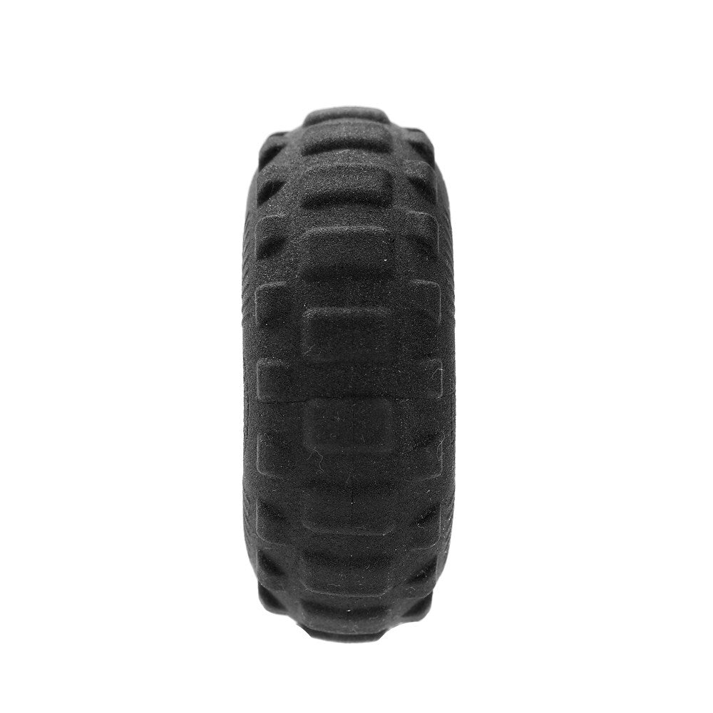 Black tire with tread pattern on a white background at Pet Servo