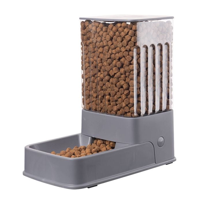 Pet food dispenser with kibble inside on a white background