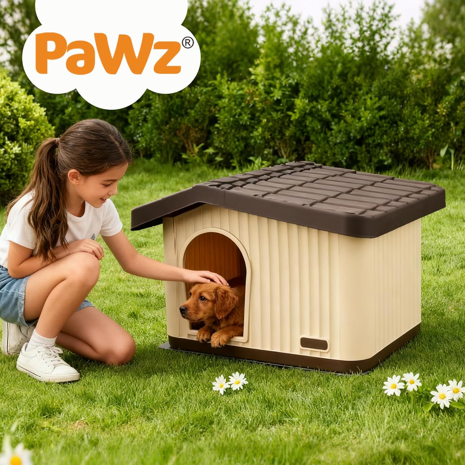 A child kneels on grass beside a small brown dog sitting inside a beige and dark brown dog house. The scene is outdoors in a garden with green grass, shrubs, and daisies, and a large PaWz logo appears in the top left corner at Pet Servo