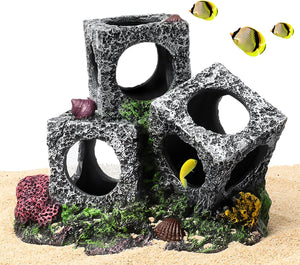 Decorative aquarium rocks with holes and fish on a sandy background at Pet Servo