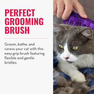A gray and white cat lying on a blue blanket while a human hand uses a purple pet grooming brush on its fur. The left side has text reading 'PERFECT GROOMING BRUSH' and additional descriptive copy at Pet Servo