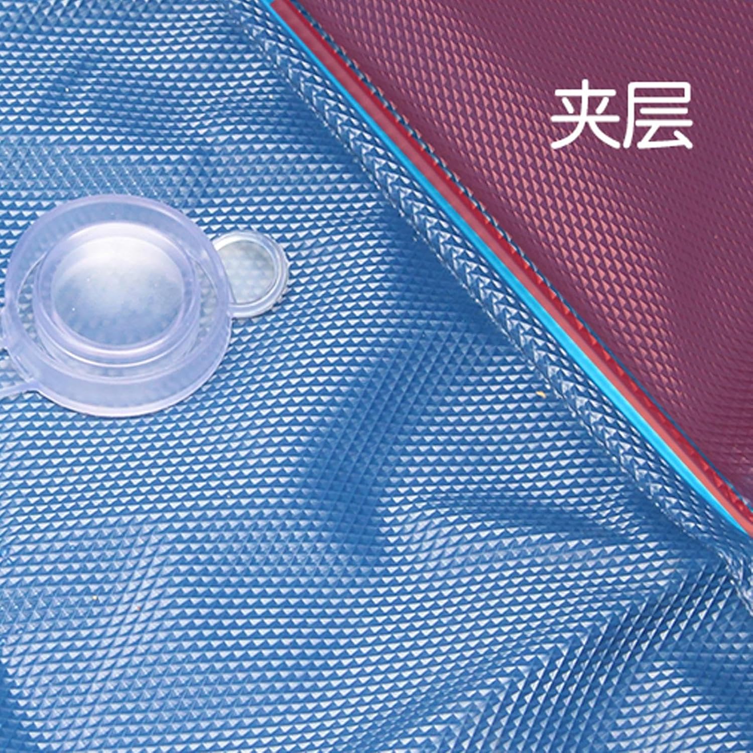 Close-up of a blue textured surface with a red corner and clear circular object at Petservo