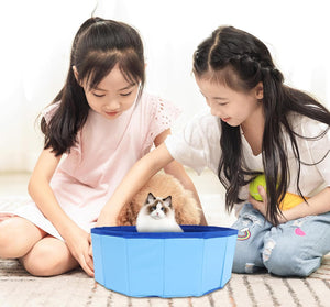 Two children with a cat inside a blue pet bathtub on a light background at Pet Servo