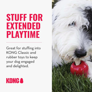 Promotional graphic for KONG dog toys with text on the left and a close-up photo of a fluffy white and black dog chewing a red KONG toy in grass on the right at Pet Servo