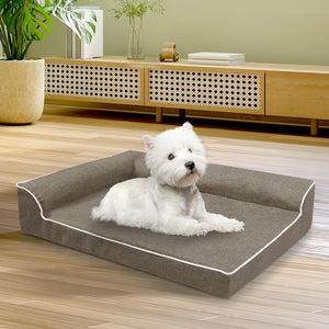 White dog lying on a gray pet bed in a room with wooden flooring and furniture at Pet Servo