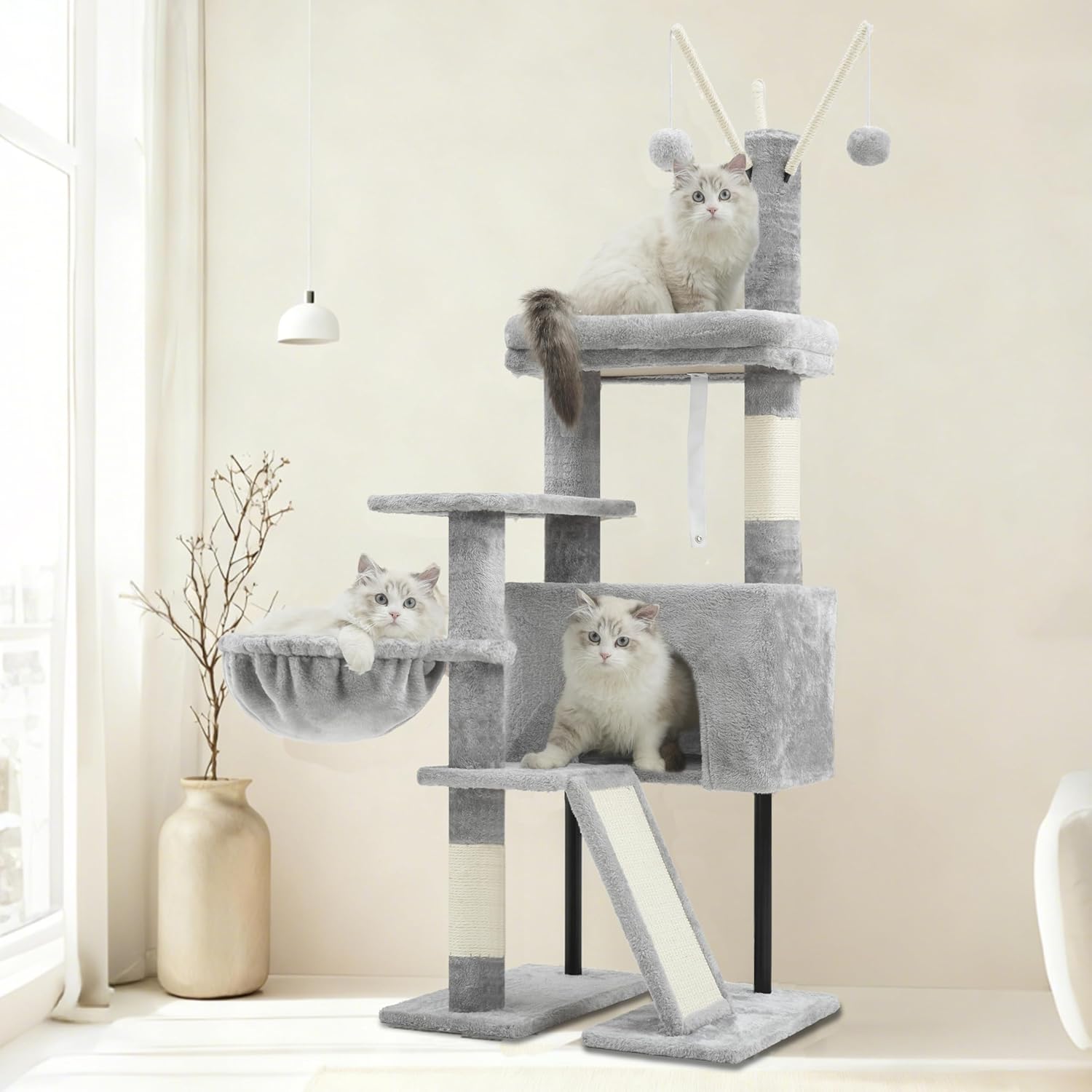 Gray cat tree with multiple levels and a hammock in a room setting at Pet Servo