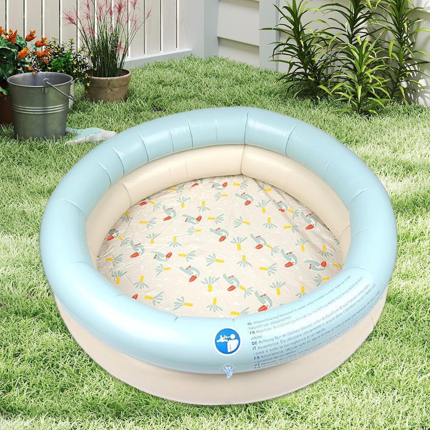 Inflatable children's pool with floral pattern on grass at Pet Servo
