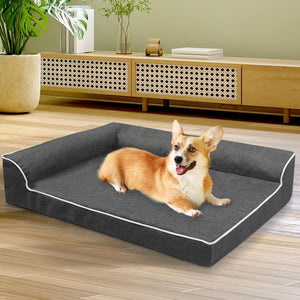 Dog lying on a gray pet bed in a room with wooden flooring and furniture at Pet Servo
