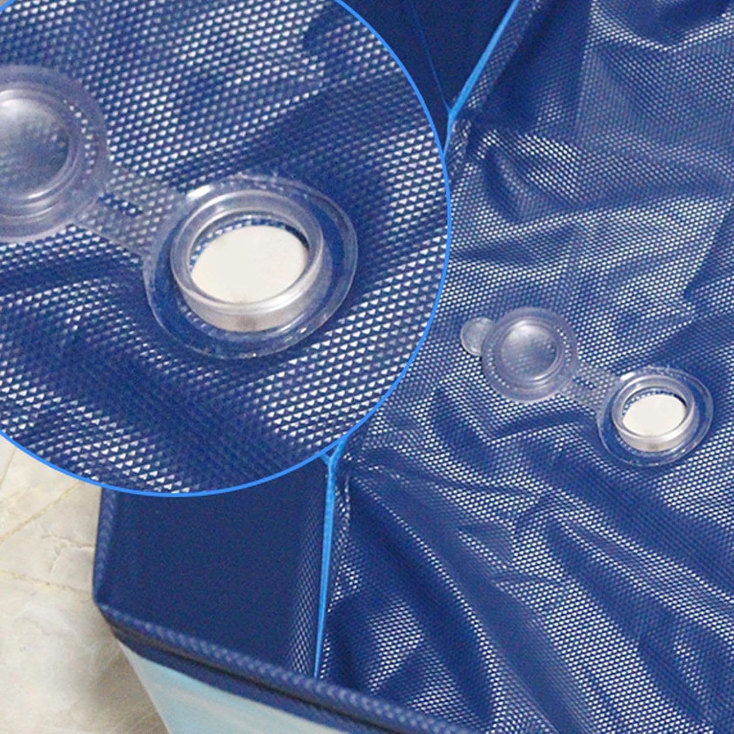 Close-up of a blue inflatable pool with bubble texture and clear valve covers at Petservo