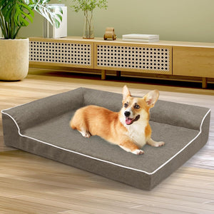 Dog lying on a large gray pet bed in a room with wooden flooring and furniture at Pet Servo