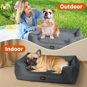 Dog lying on a gray pet bed with 'Indoor' label, and another dog on a similar bed with 'Outdoor' label at Pet Servo