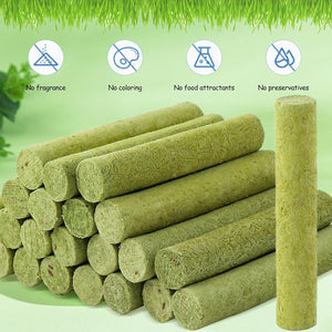Stack of green plant-based products with icons and text indicating no fragrance, no coloring, no food attractants, and no preservatives on a green background at Pet Servo