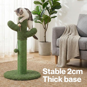A gray and white cat is climbing on a green cactus-shaped cat tree with a thick round base in a bright living room. White text in the lower right reads 'Stable 2cm Thick base' at Pet Servo