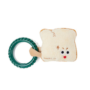 A baby teething toy featuring a plush bread slice with a cute face and a green ring rattle attached, on a solid white background at Pet Servo