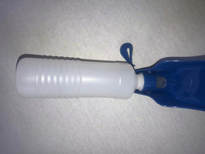 White bottle with blue cap on a gray surface at Pet Servo