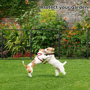 Two dogs playing on a green lawn in front of a black metal garden fence with a lush garden and brick wall background. The text 'Protect your garden' is displayed at the top at Pet Servo