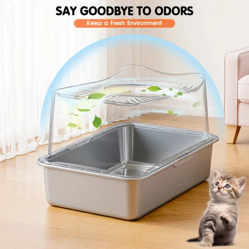 A rectangular stainless steel cat litter box with a clear hinged lid and a raised ventilation tray, shown on a wooden floor in a room setting. A small kitten stands at the lower right, and marketing text at the top reads 'SAY GOODBYE TO ODORS' with a blue airflow graphic above the litter box at Pet Servo