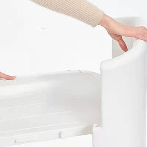 Person holding a white fitted sheet over a bed at Pet Servo