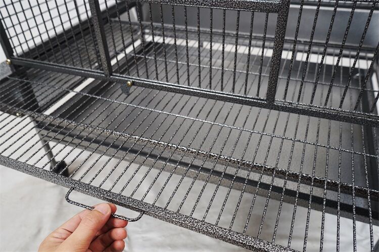 Hand holding a black metal shelf against a neutral background at Pet Servo